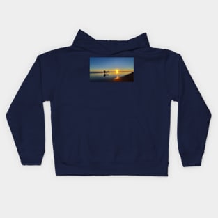 A silhouetted horse-drawn carriage on Parangtritis beach at sunset 2 Kids Hoodie